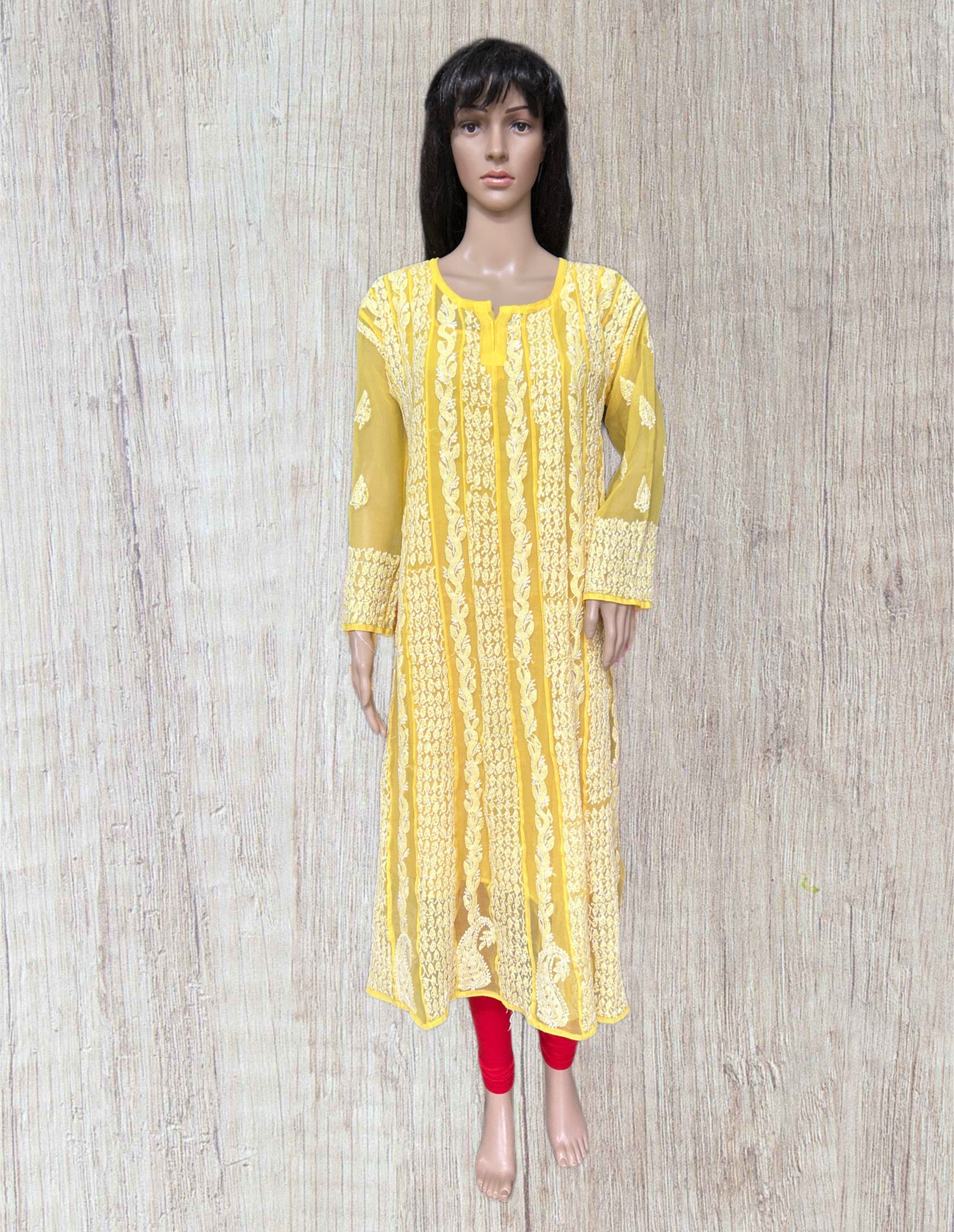 Yellow kurta worn by a mannequin on a wooden background