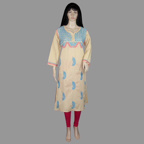 Beige embroidered dress on a mannequin against a gray background