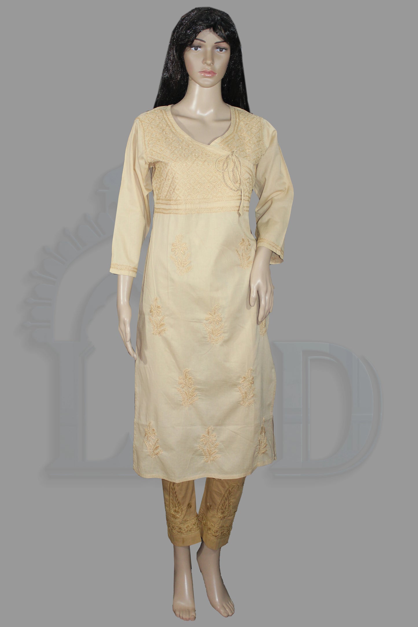 Lucknowi chikankari A cream-colored three-piece Indian ethnic wear set consisting of a long-sleeve kurta, pants, and a dupatta, displayed on a female mannequin against a solid gray background.