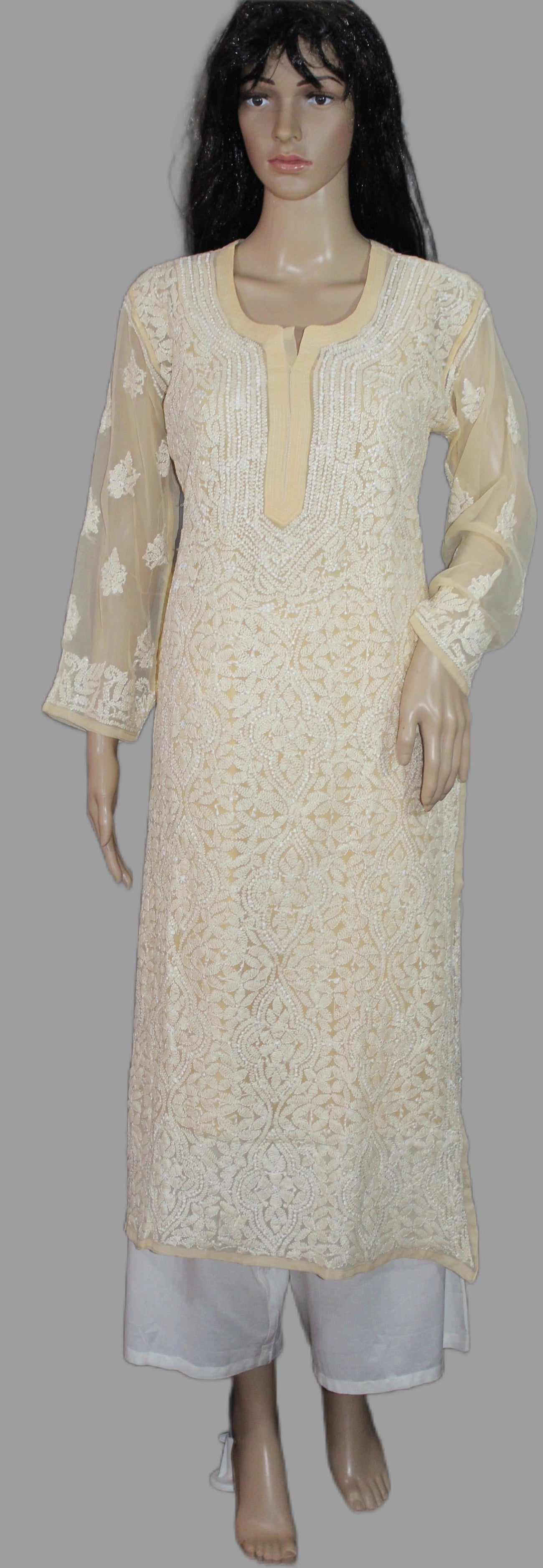 Beige lucknowi chikankari kurta with white pants on a mannequin against a gray background