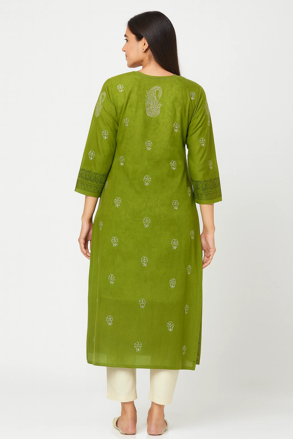 Woman wearing a lucknowi chikankari green kurta with white patterns on a white background