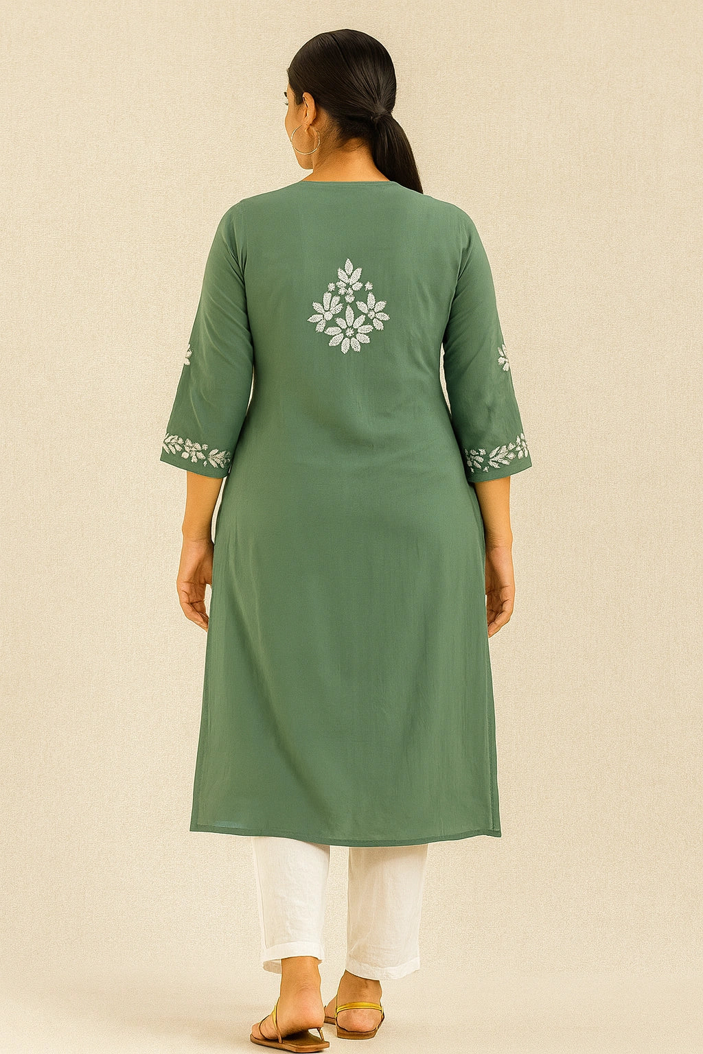 Green kurta with white floral embroidery on a beige background