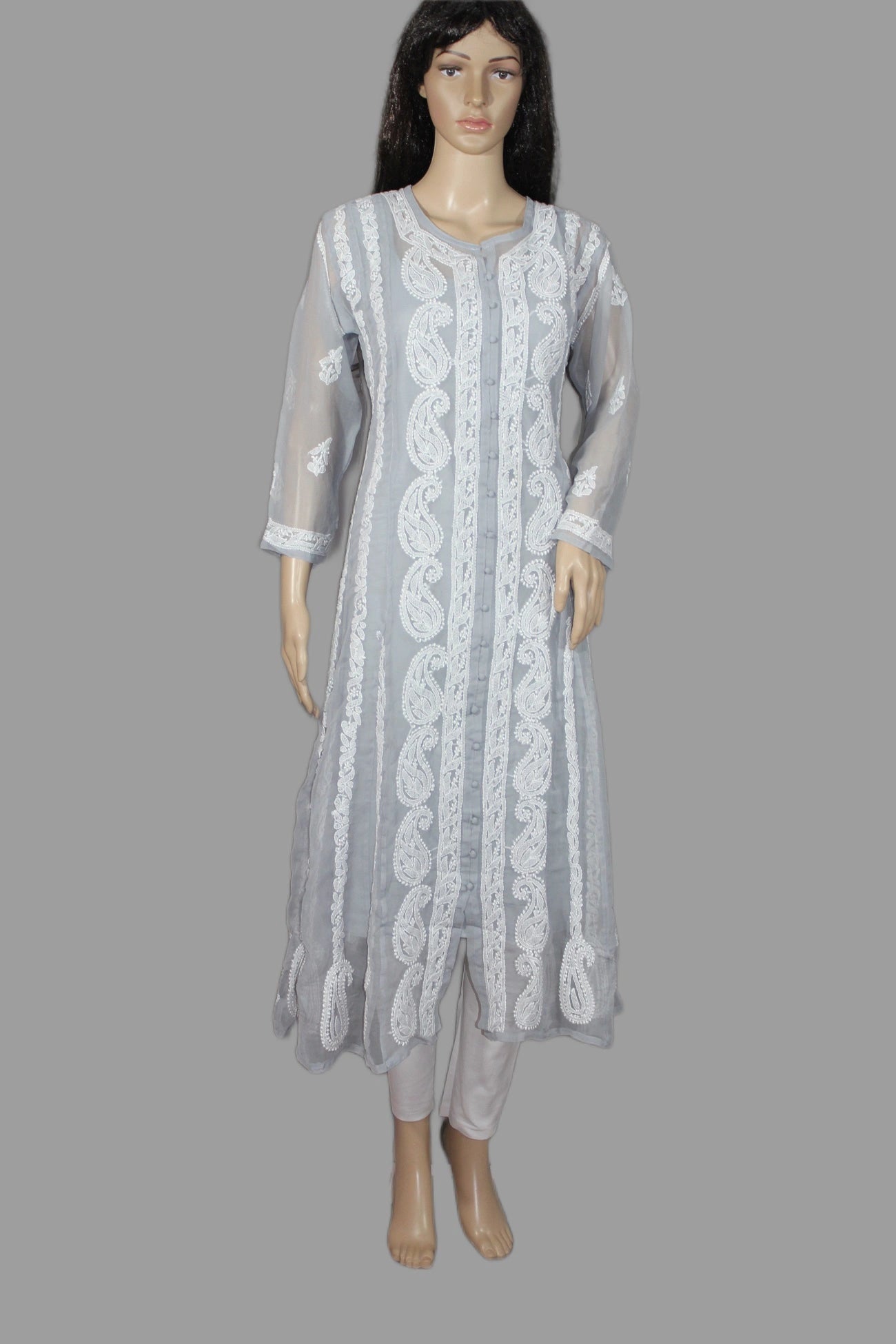 Mannequin wearing a light gray traditional outfit with intricate white embroidery on a gray background