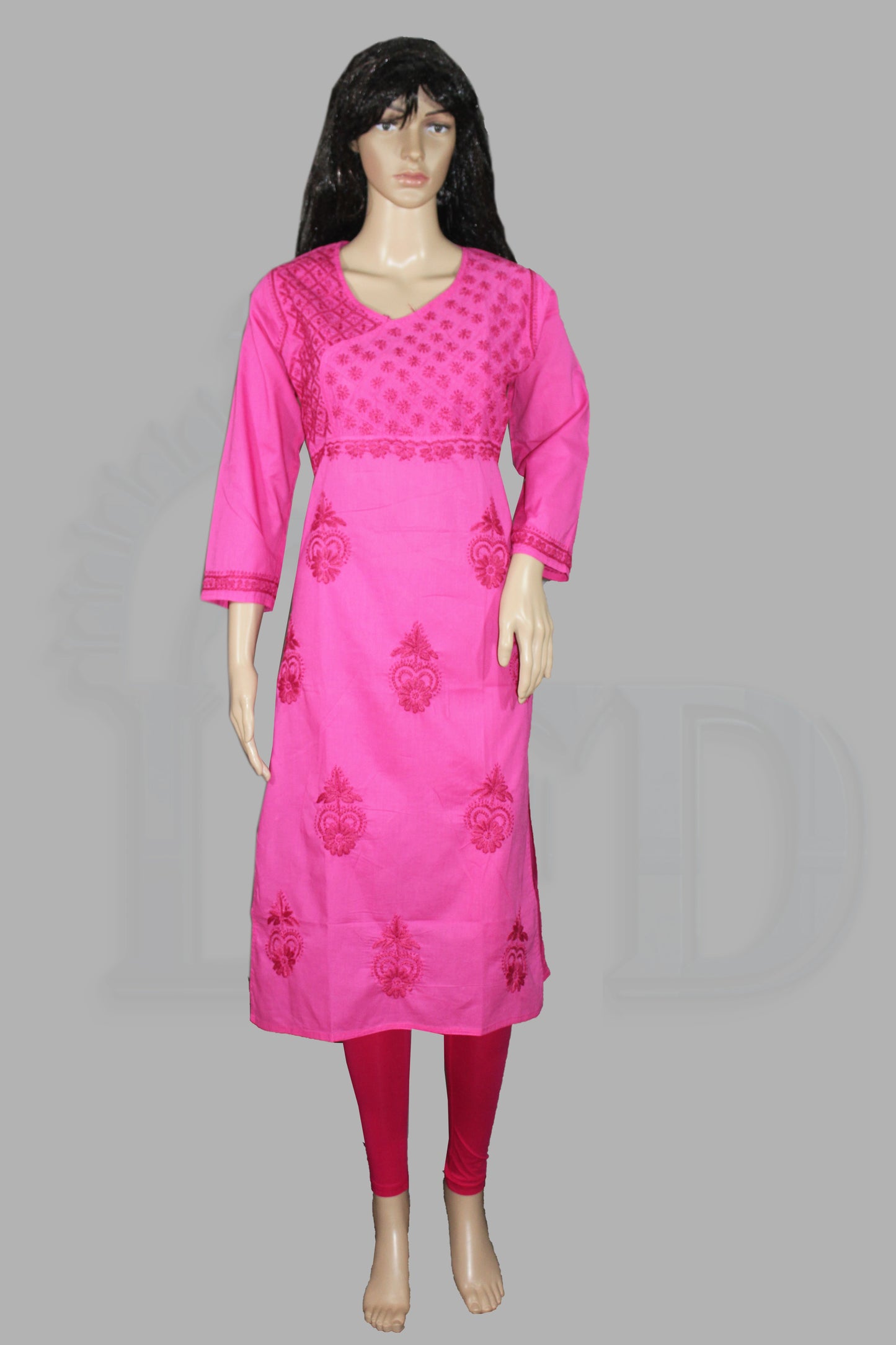 Mannequin wearing a lucknowi chikankari bright pink traditional outfit with intricate designs on a gray background