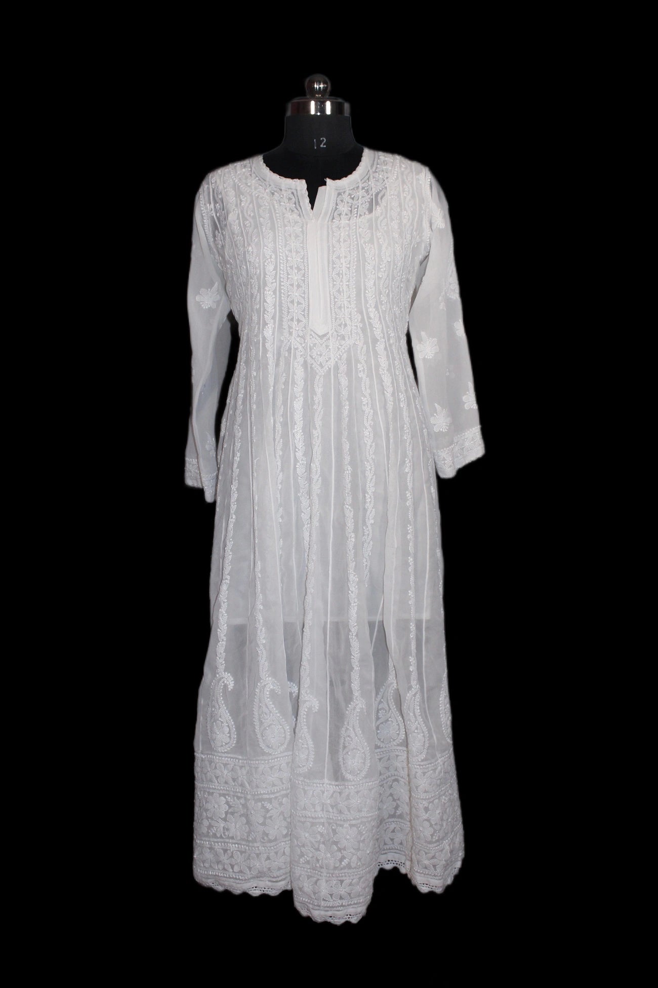 White dress on a mannequin against a black background