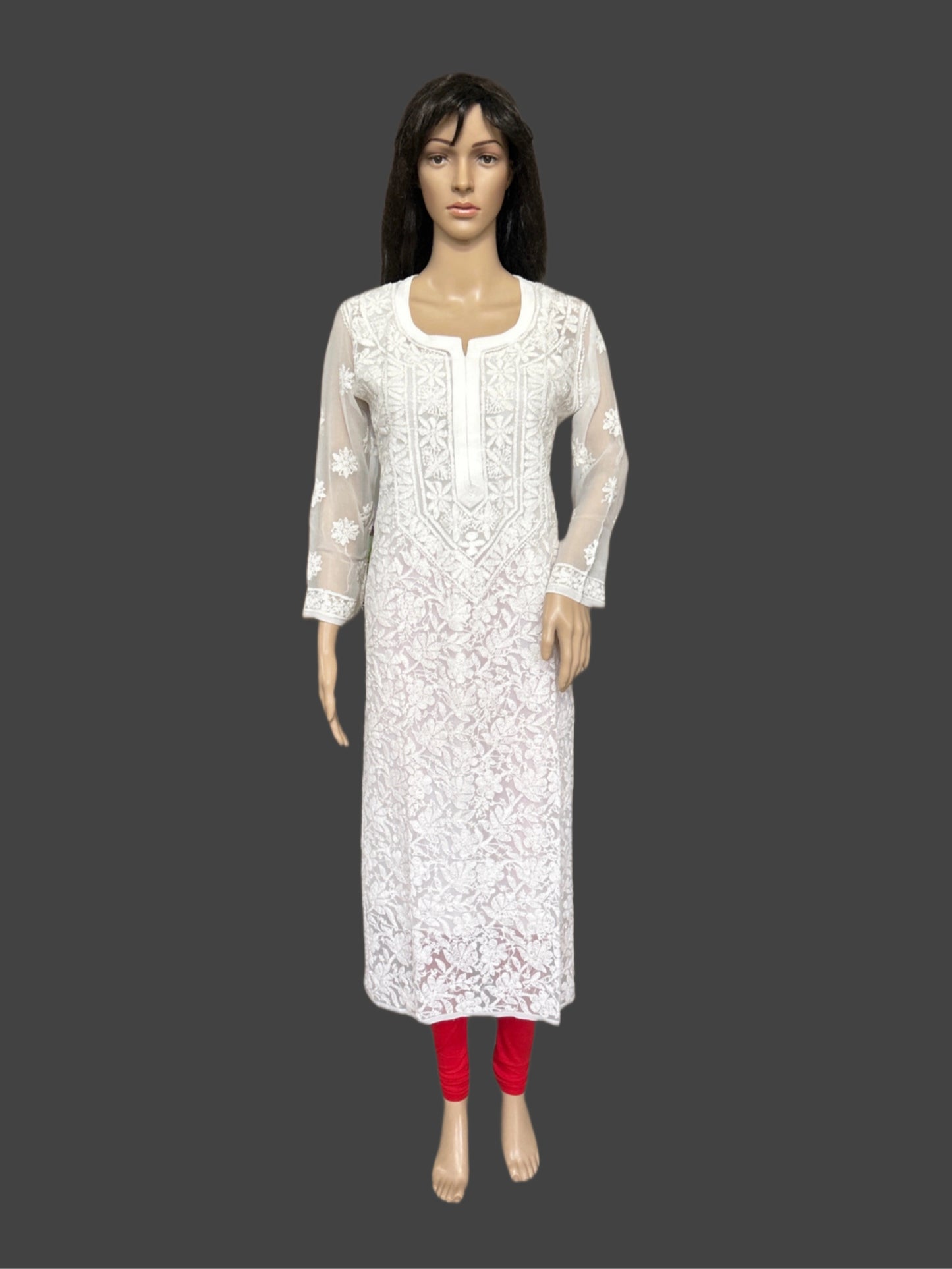 White embroidered kurta with red pants on a mannequin against a gray background