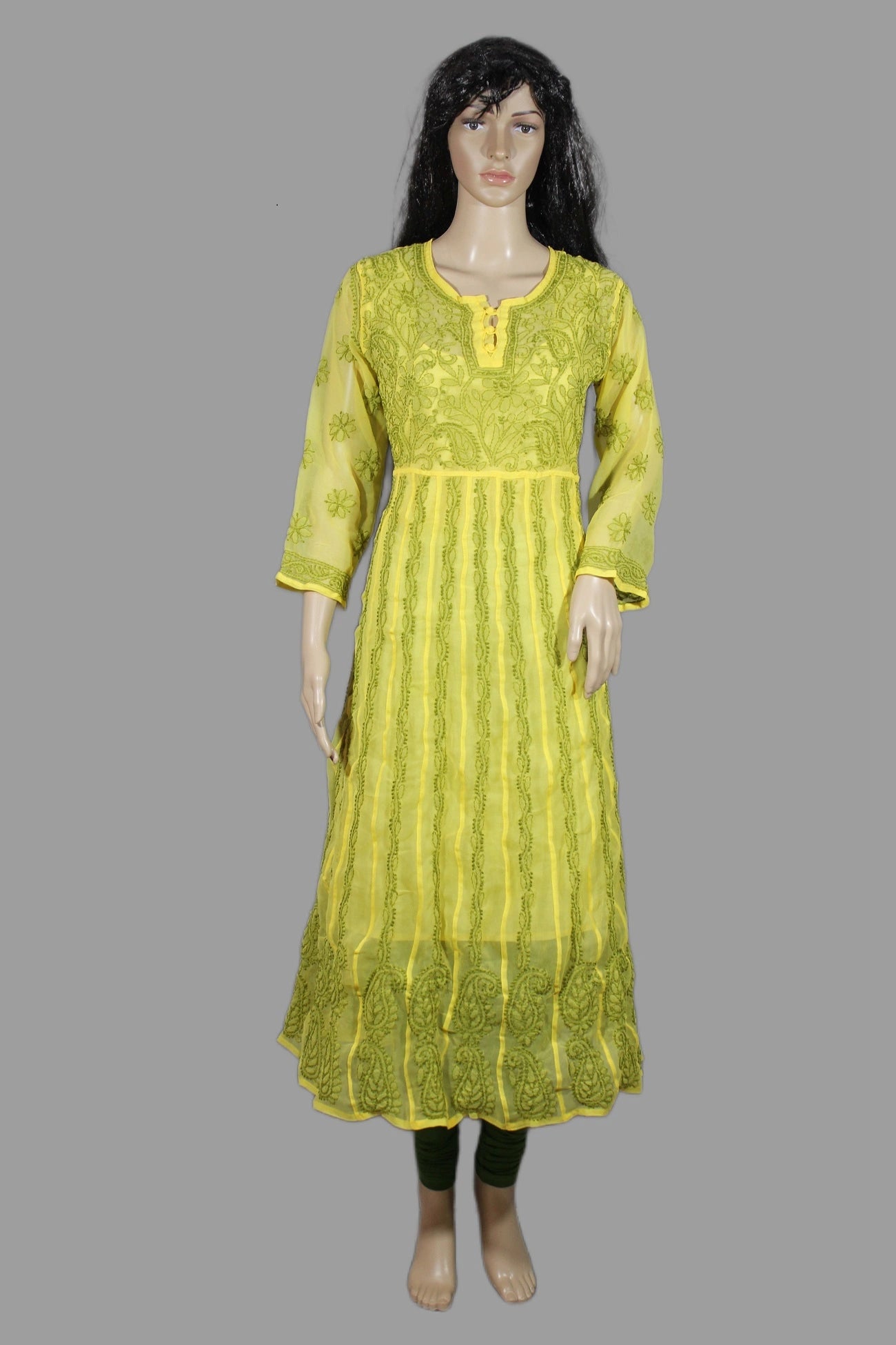 Green dress on a mannequin against a gray background