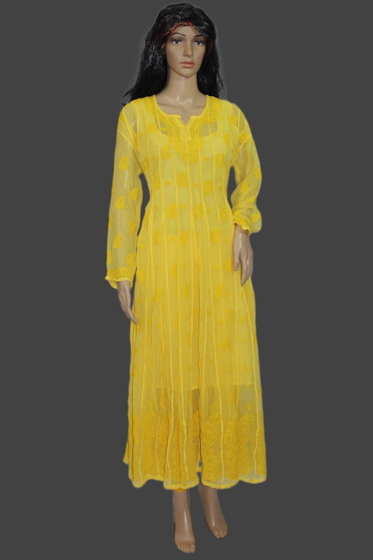 Yellow dress on a mannequin against a gray background