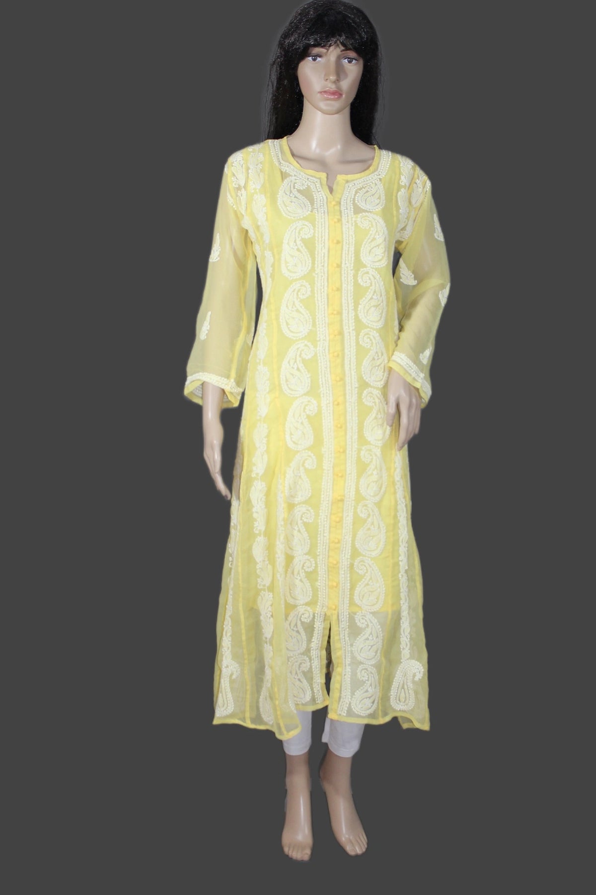 A yellow semi-sheer kurta with white paisley embroidery, displayed on a female mannequin against a dark gray background.