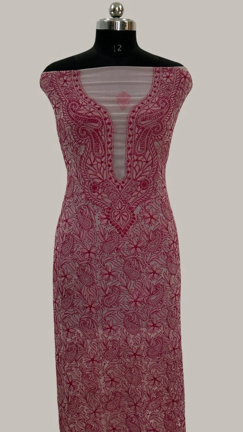 lucknowi chikankari Red lace dress on a mannequin against a plain background