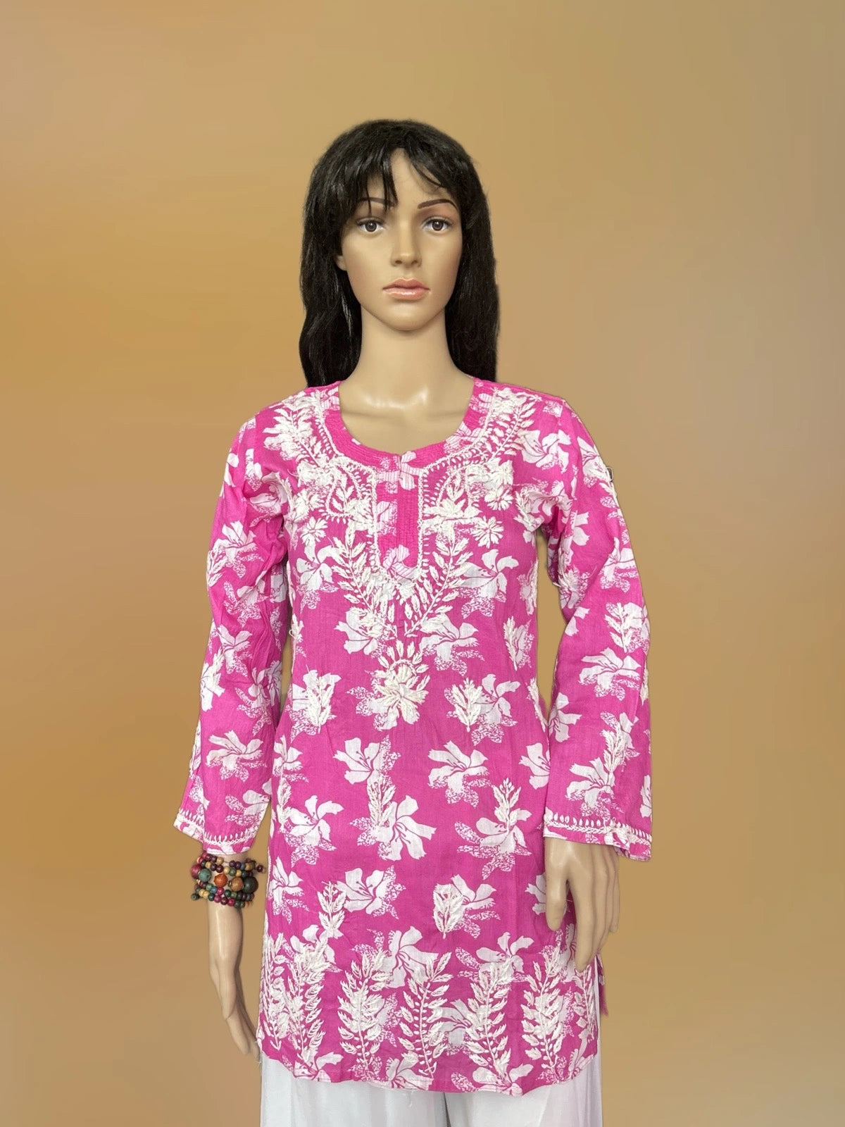 lucknowi chikankari Mannequin wearing a pink floral top against a beige background