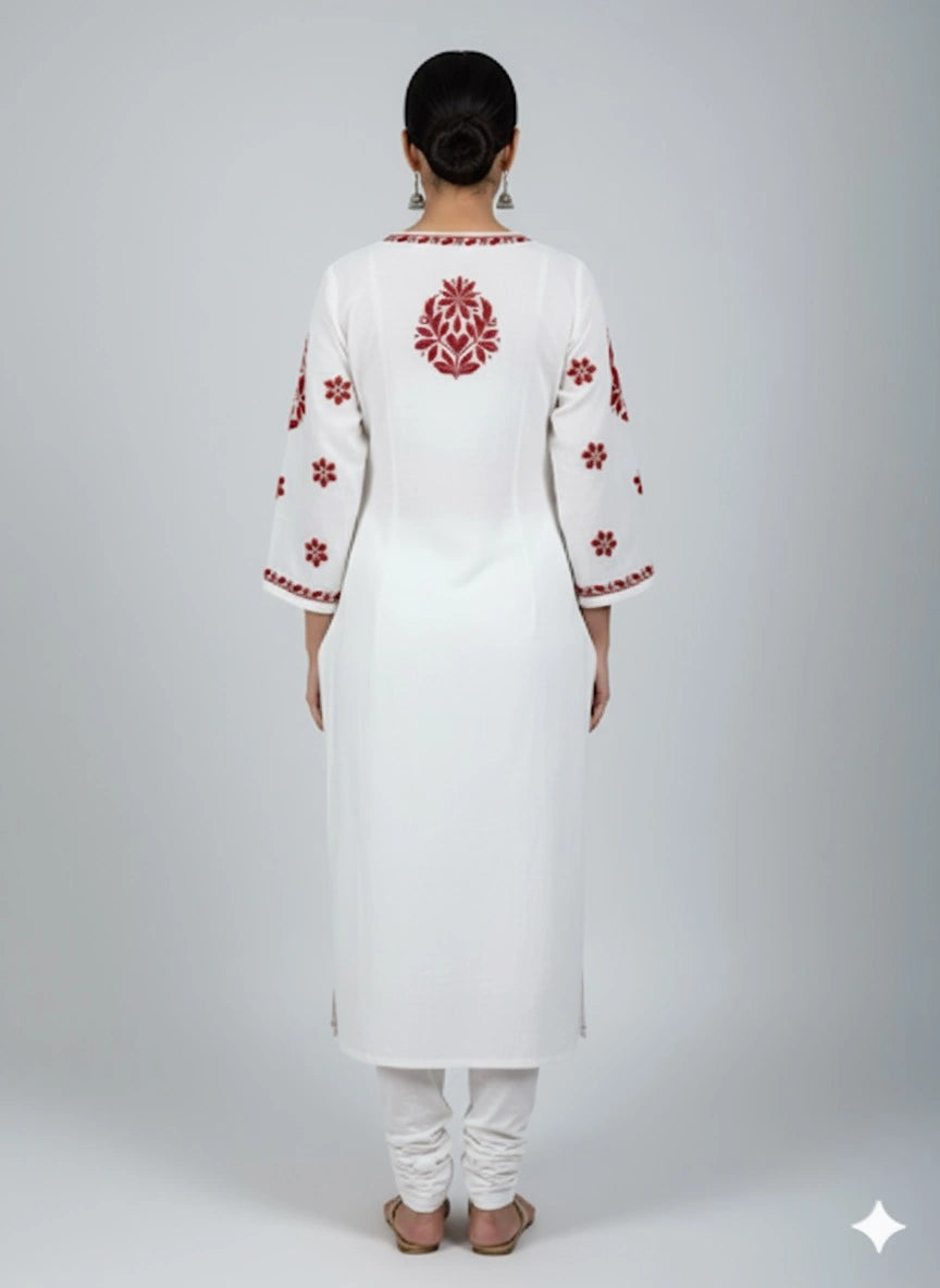 White kurta with red embroidery on a plain background