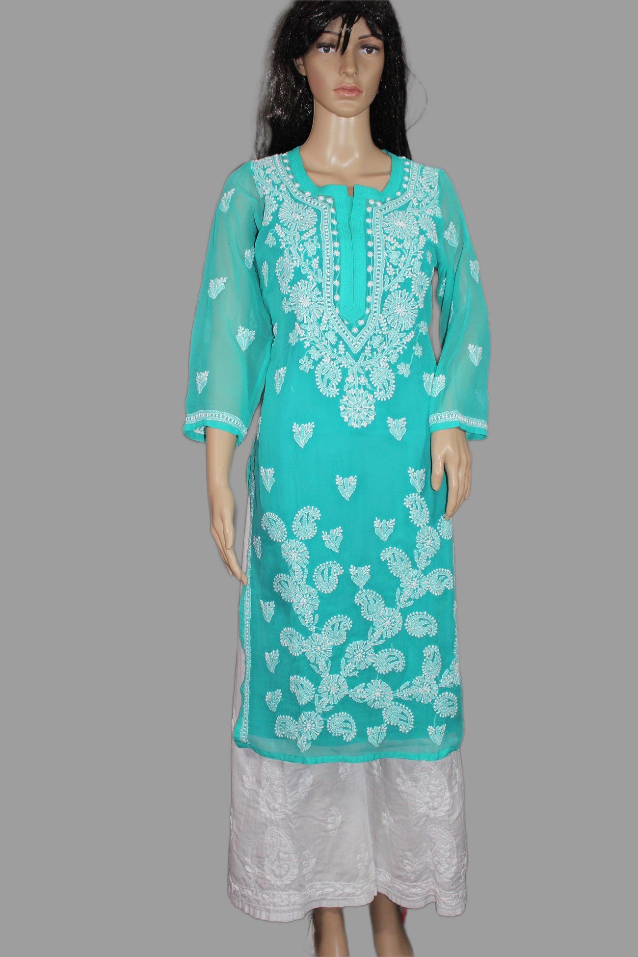 Teal embroidered kurta on a mannequin against a gray background