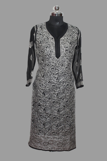 Black and white patterned dress on a mannequin against a gray background