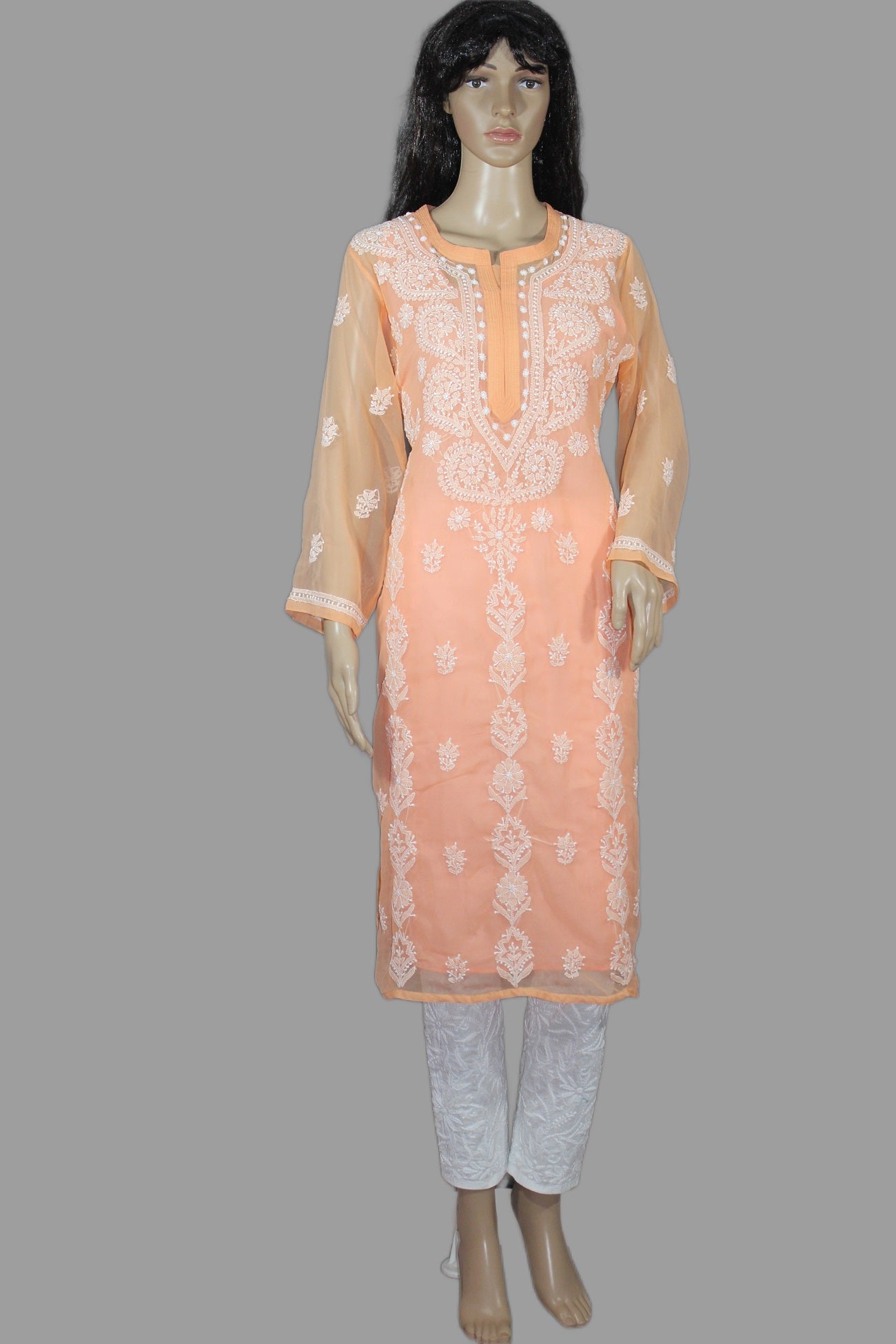 Mannequin wearing a peach embroidered kurta with white pants on a gray background