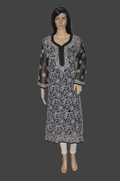 Mannequin wearing a black and white patterned dress on a gray background