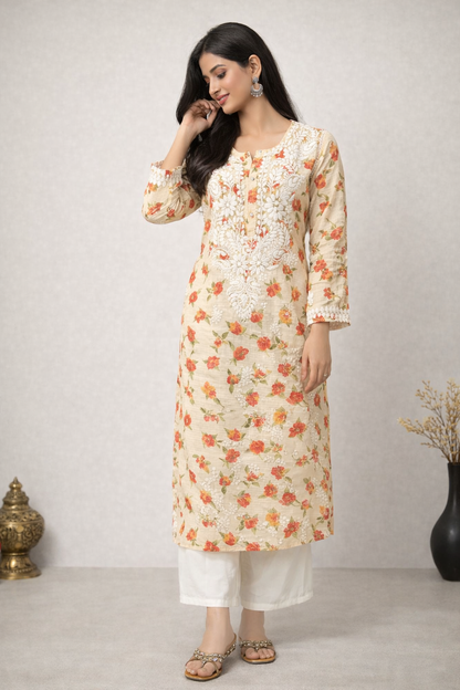 Woman wearing a floral kurta with white pants against a plain background
