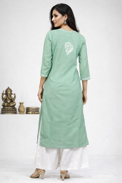 Woman wearing a light green kurta with white pants on a white background
