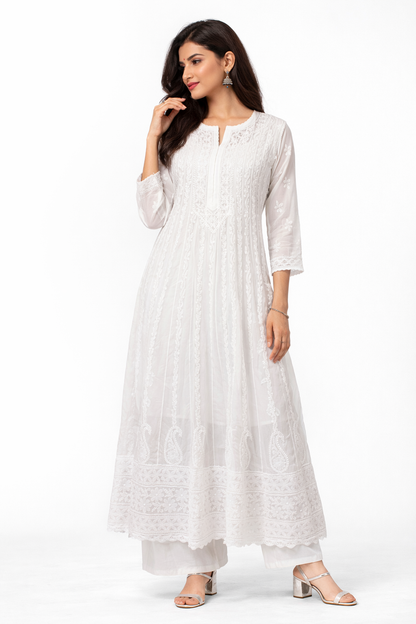 Woman wearing a white long dress with a subtle pattern on a white background