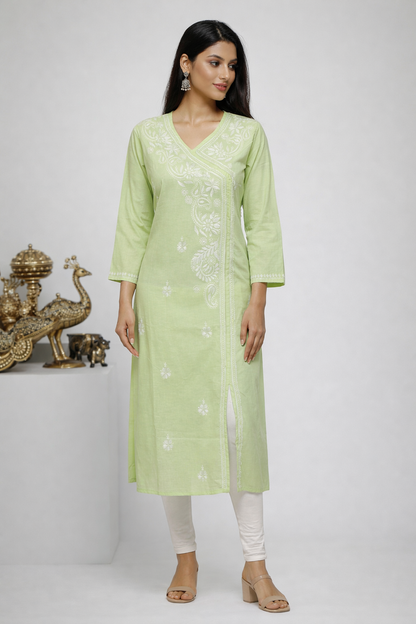 Woman wearing a light green kurta with white embroidery on a white background