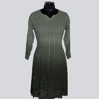Green dress on a mannequin against a gray background