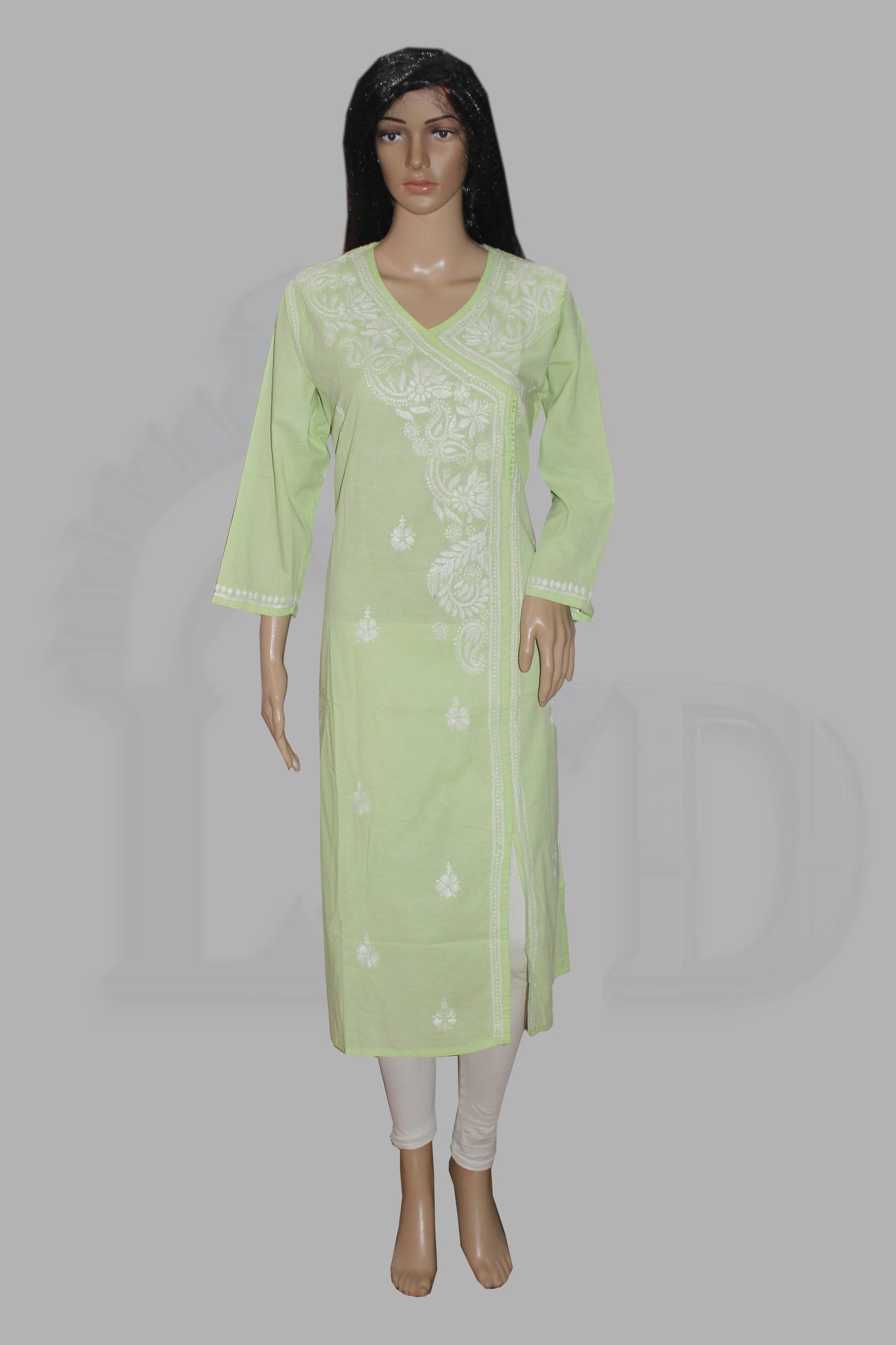 Light green kurta with white embroidery on a mannequin against a gray background