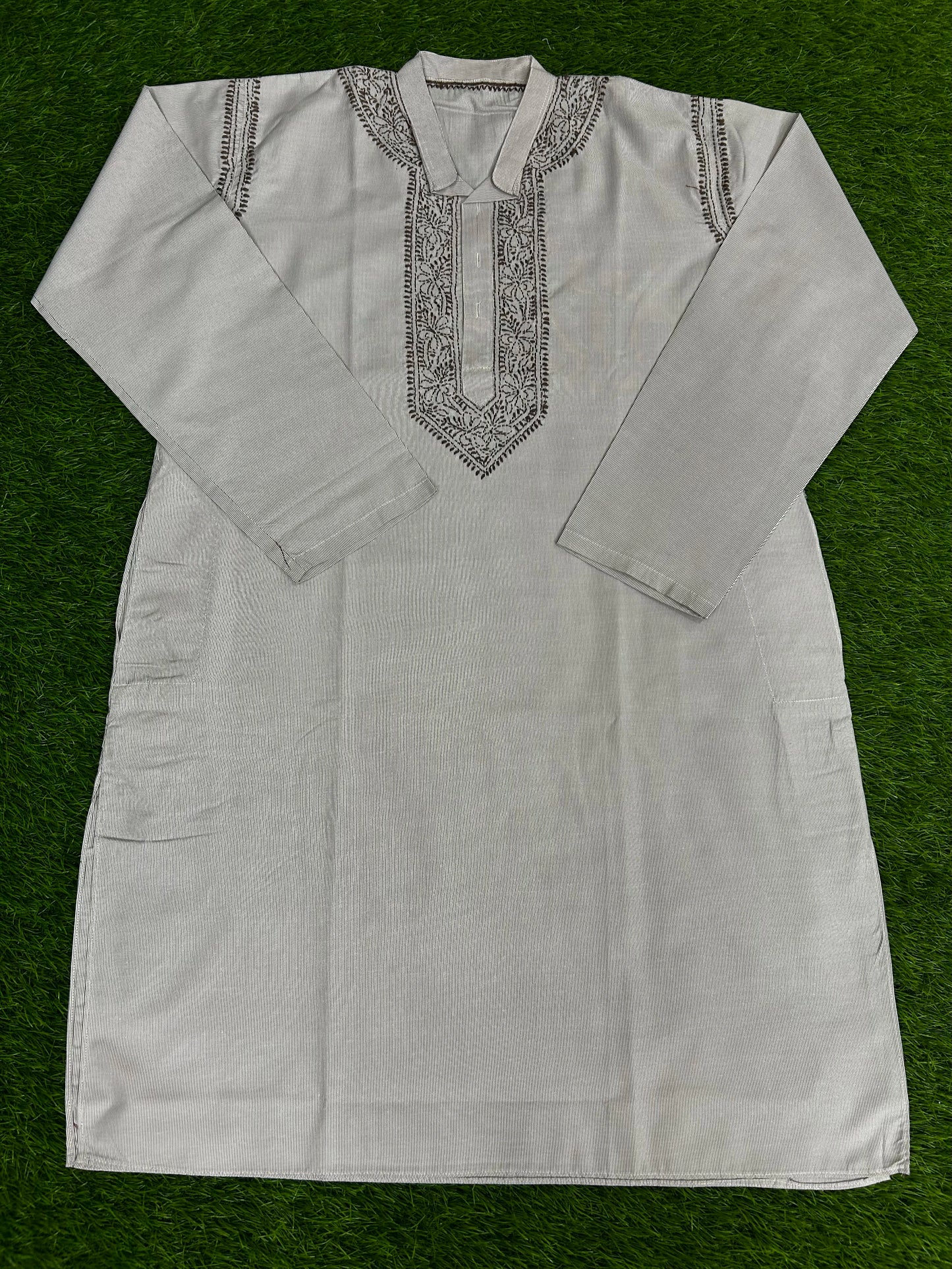 White embroidered kurta on a green background
