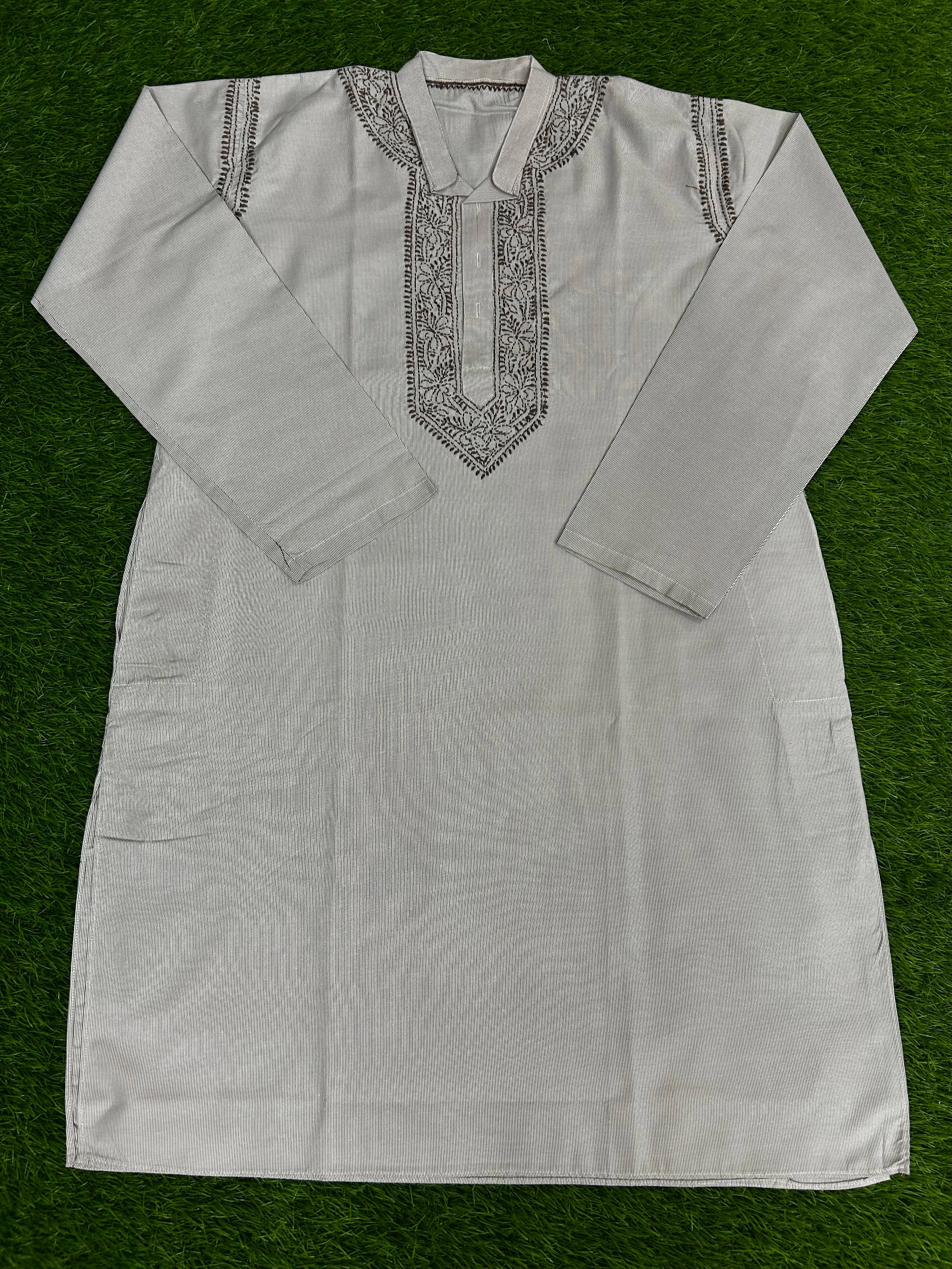 White embroidered kurta on a green background