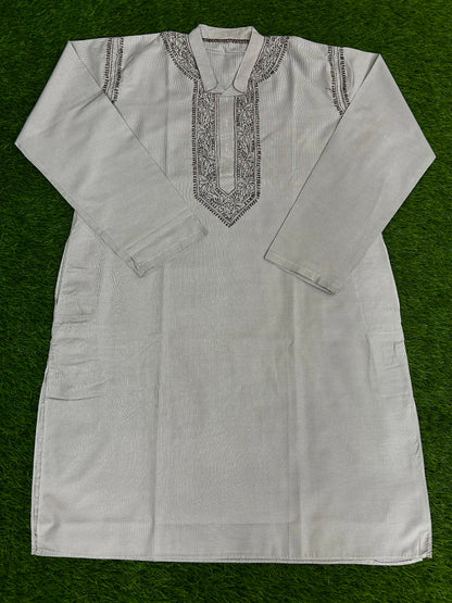White embroidered kurta on a green background
