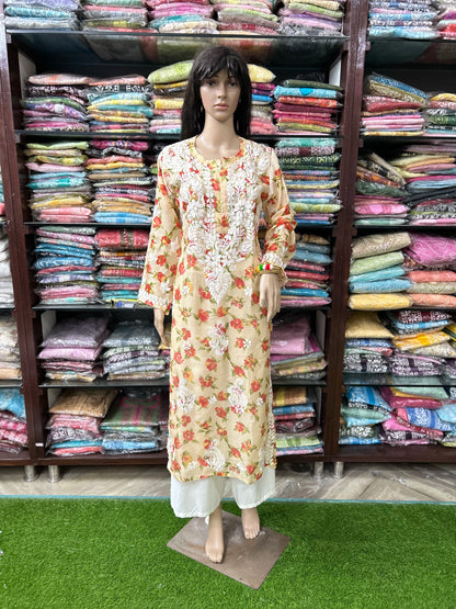 Mannequin wearing a floral dress in front of shelves filled with colorful fabrics.