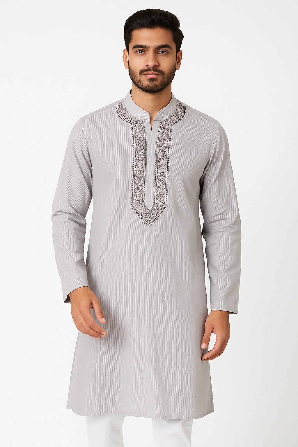 Man wearing a light gray kurta with white embroidery on a white background