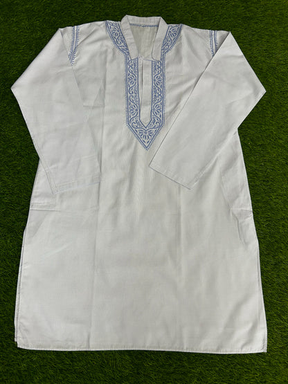 White embroidered shirt on a green background
