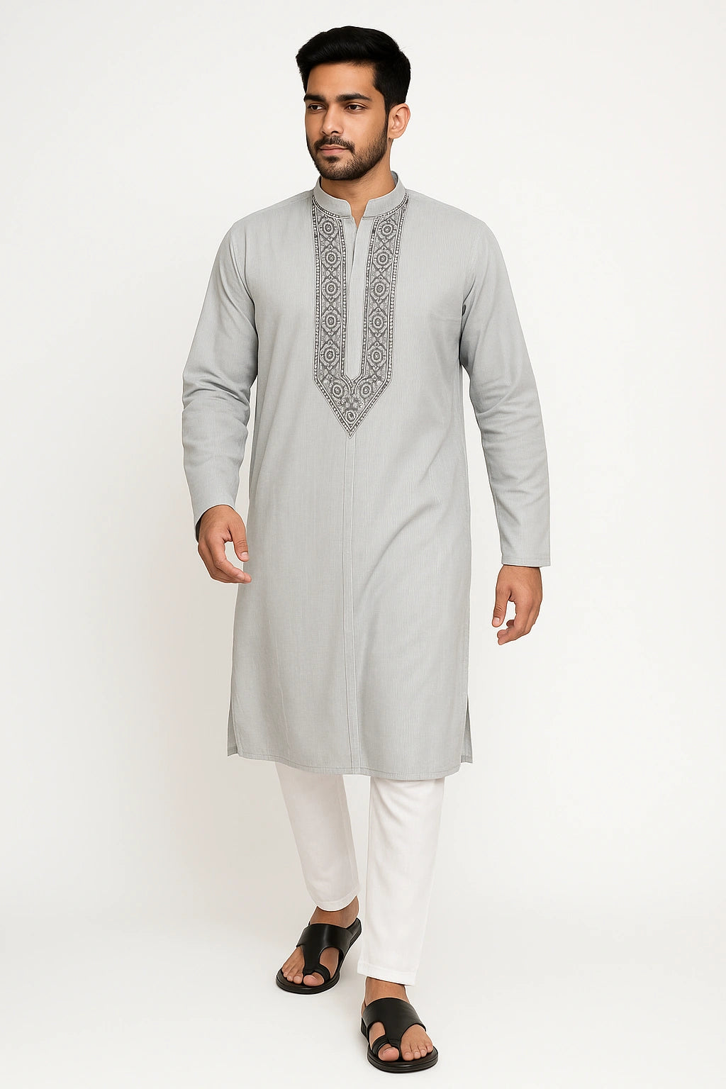 Man wearing a lucknowi chikankari light gray kurta with white pants on a white background