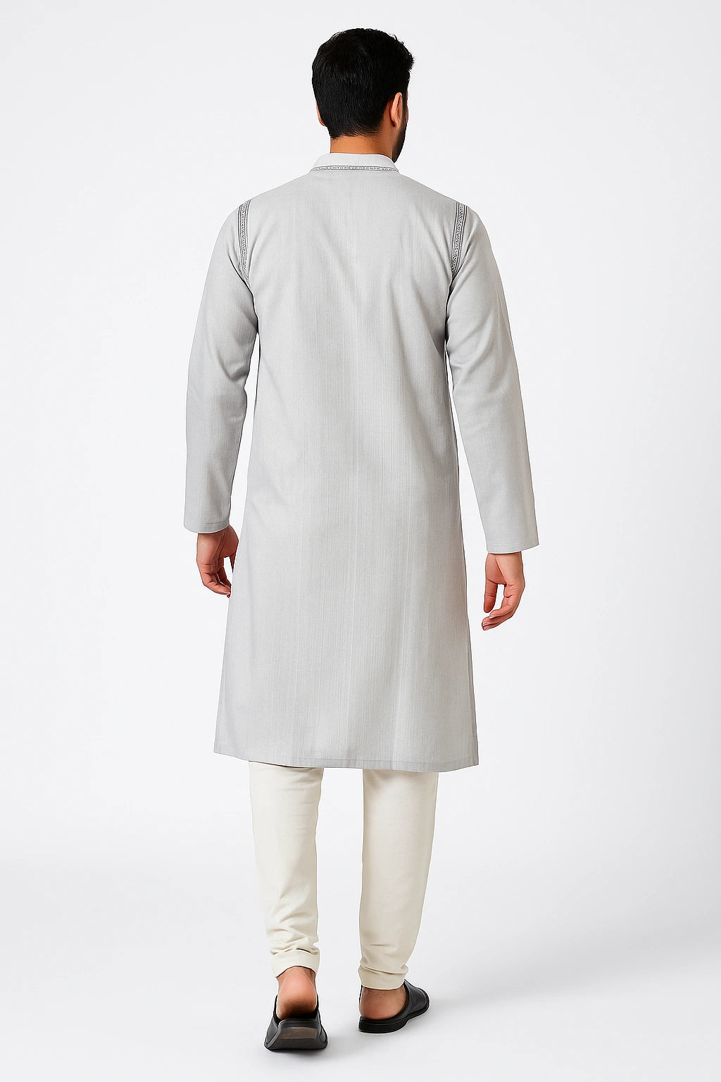 Man wearing a lucknowi chikankari light gray kurta with white pants on a white background