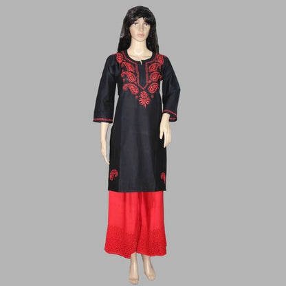Black and red embroidered dress on a mannequin against a gray background