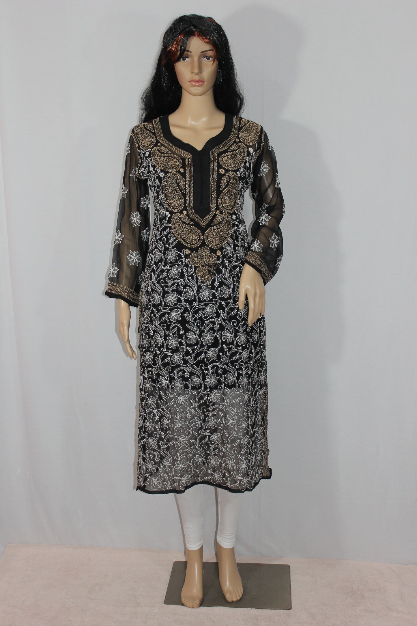 Mannequin wearing a black and white patterned dress against a plain background