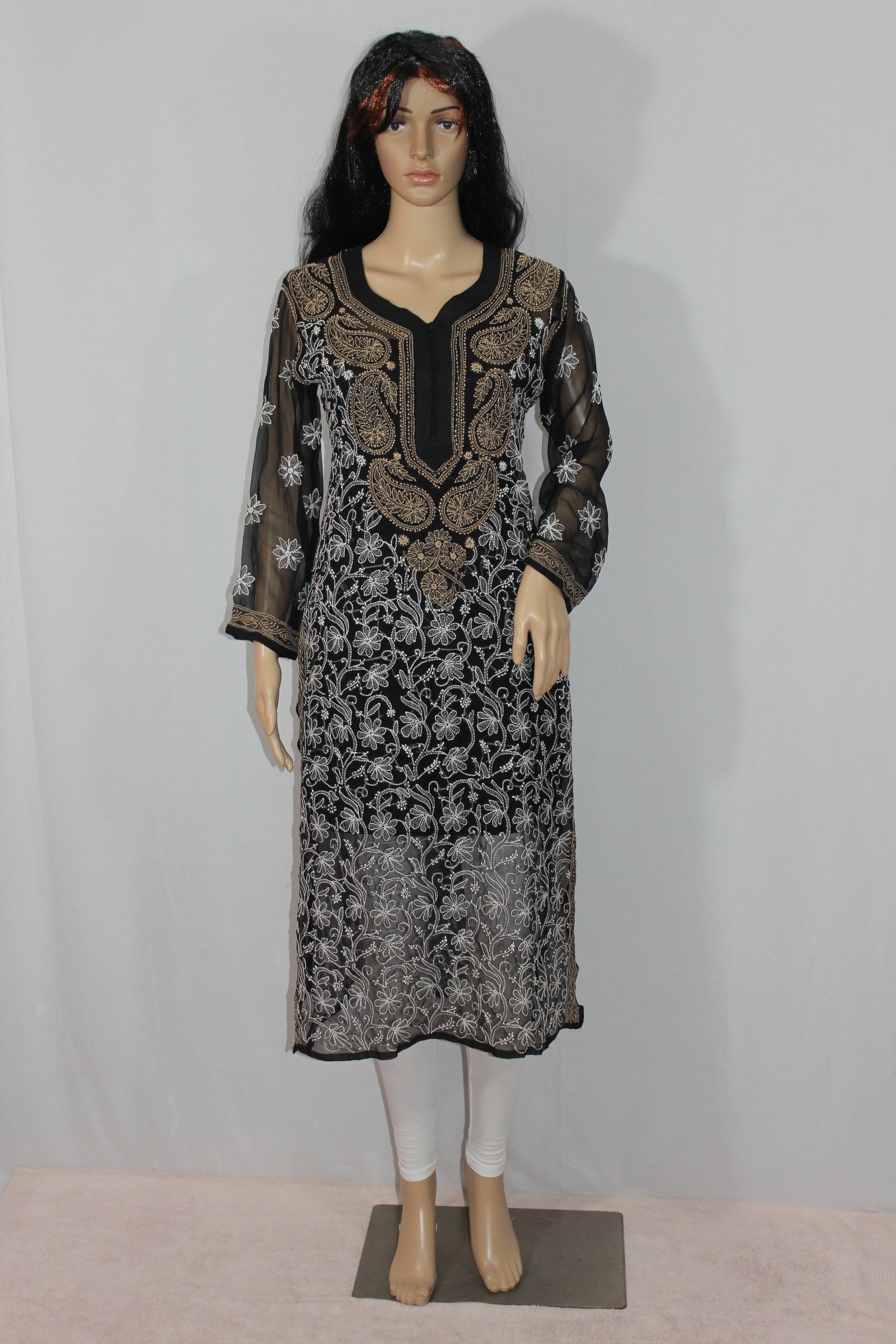 Mannequin wearing a black and white patterned dress against a plain background