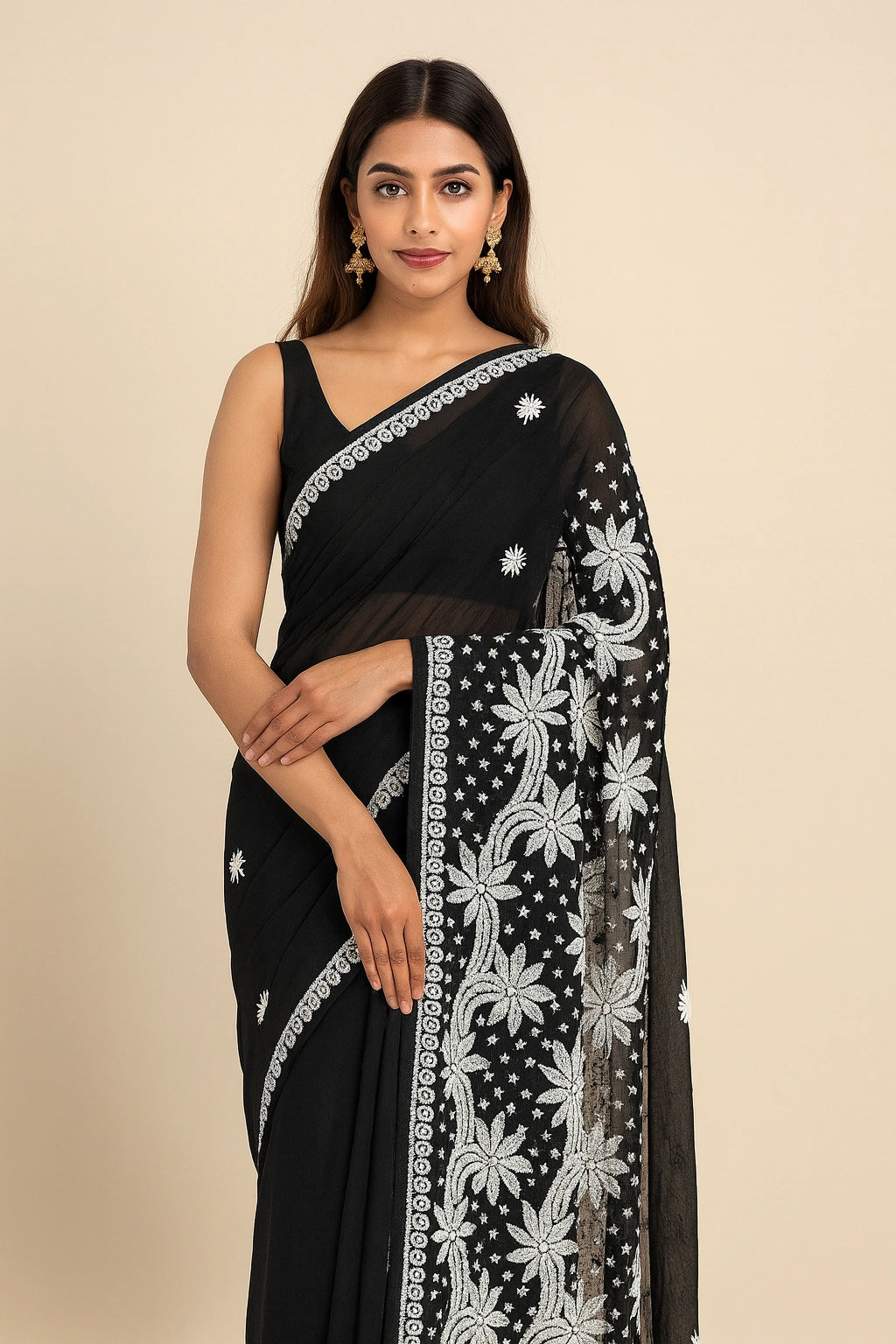 Woman wearing a lucknowi chikankari black saree with white floral patterns on a beige background
