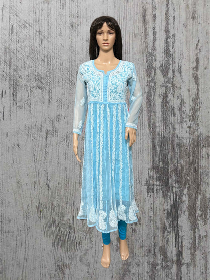 Mannequin wearing a light blue embroidered dress on a textured gray background