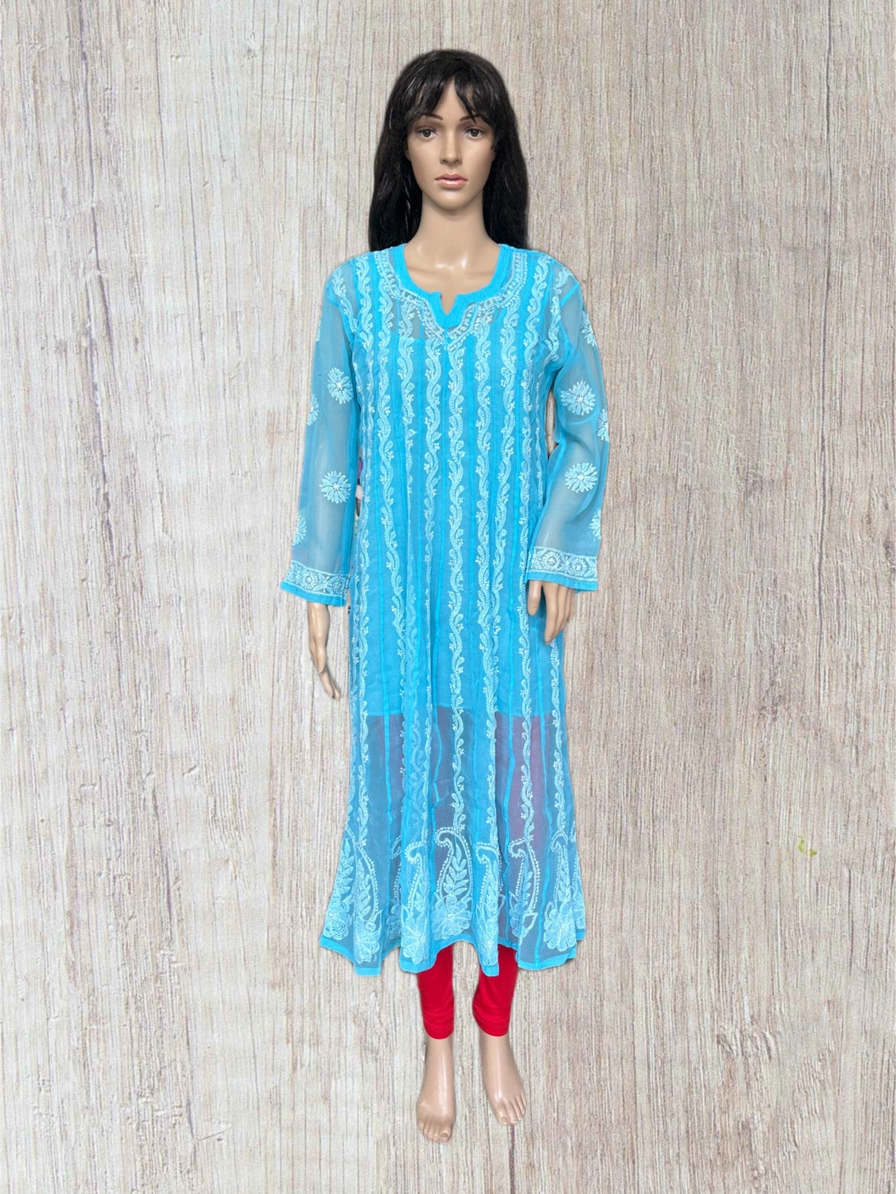 Blue hand embroidered anarkali kurta on a mannequin against a wooden background