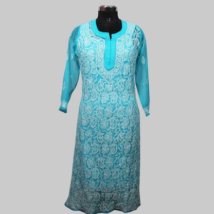 Turquoise embroidered dress on a mannequin against a gray background
