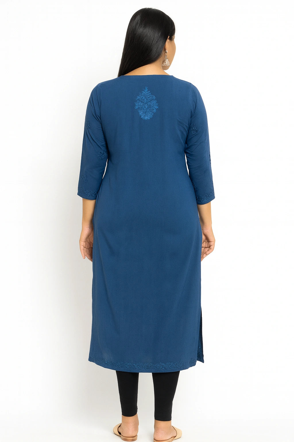 Woman wearing a lucknowi chikankari blue kurta with a white background