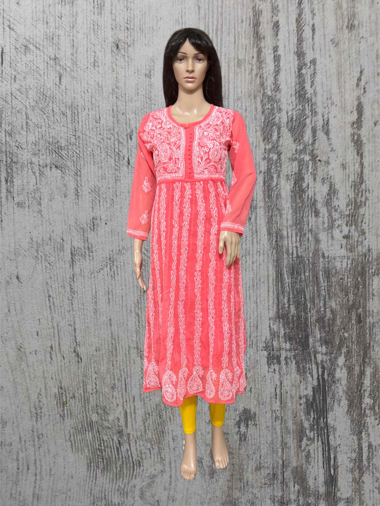 Mannequin wearing a pink embroidered kurta against a textured gray background