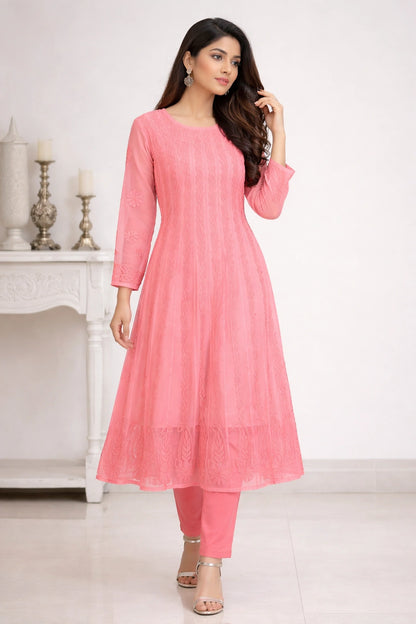 Woman wearing a pink kurta with pants against a white background