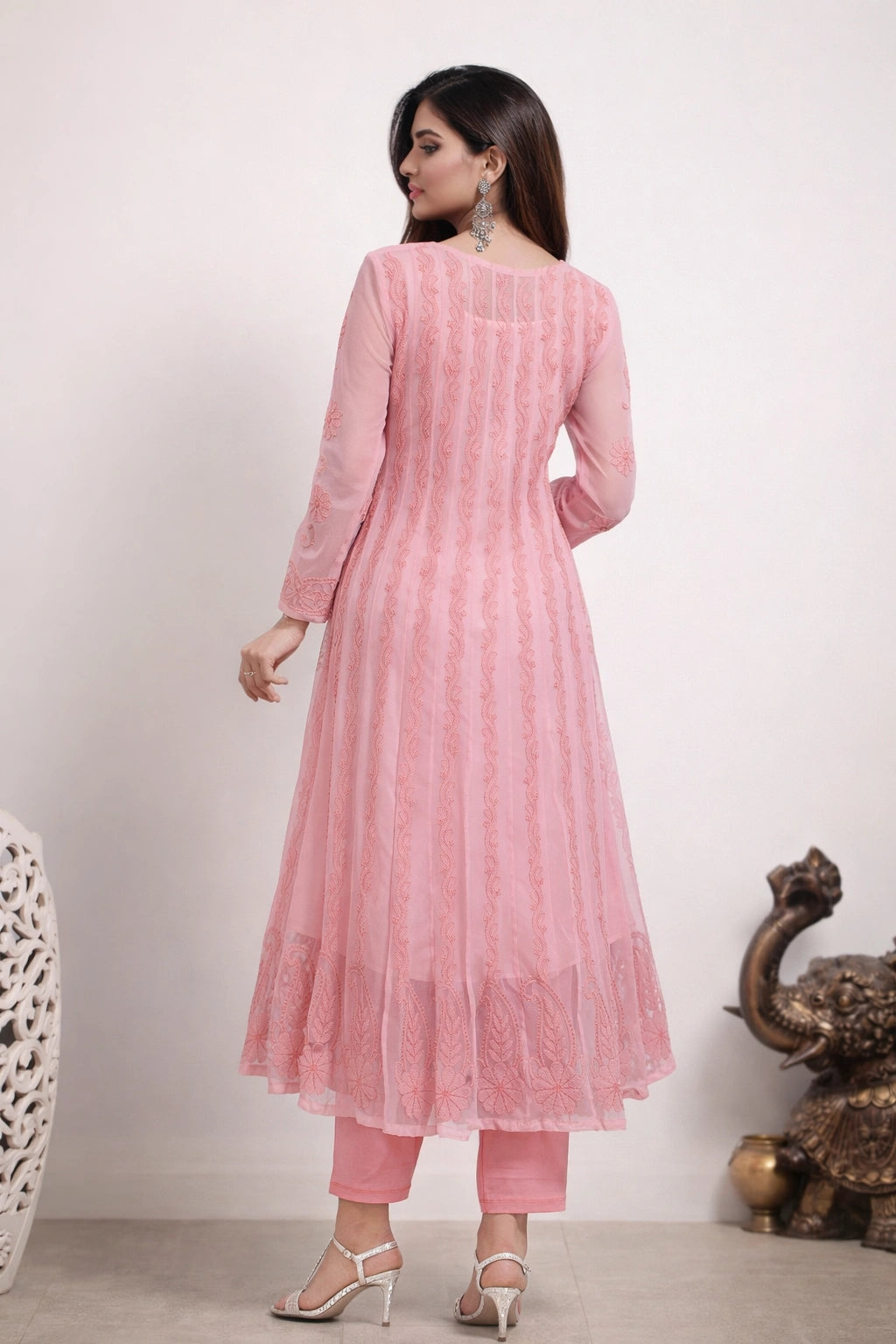 Woman wearing a pink traditional outfit with a white background