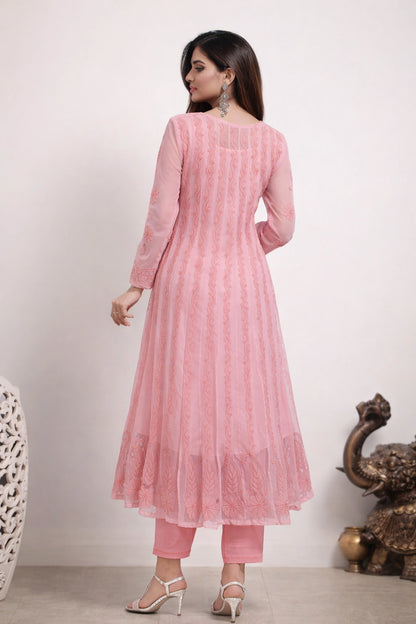 Woman wearing a pink traditional outfit with a white background