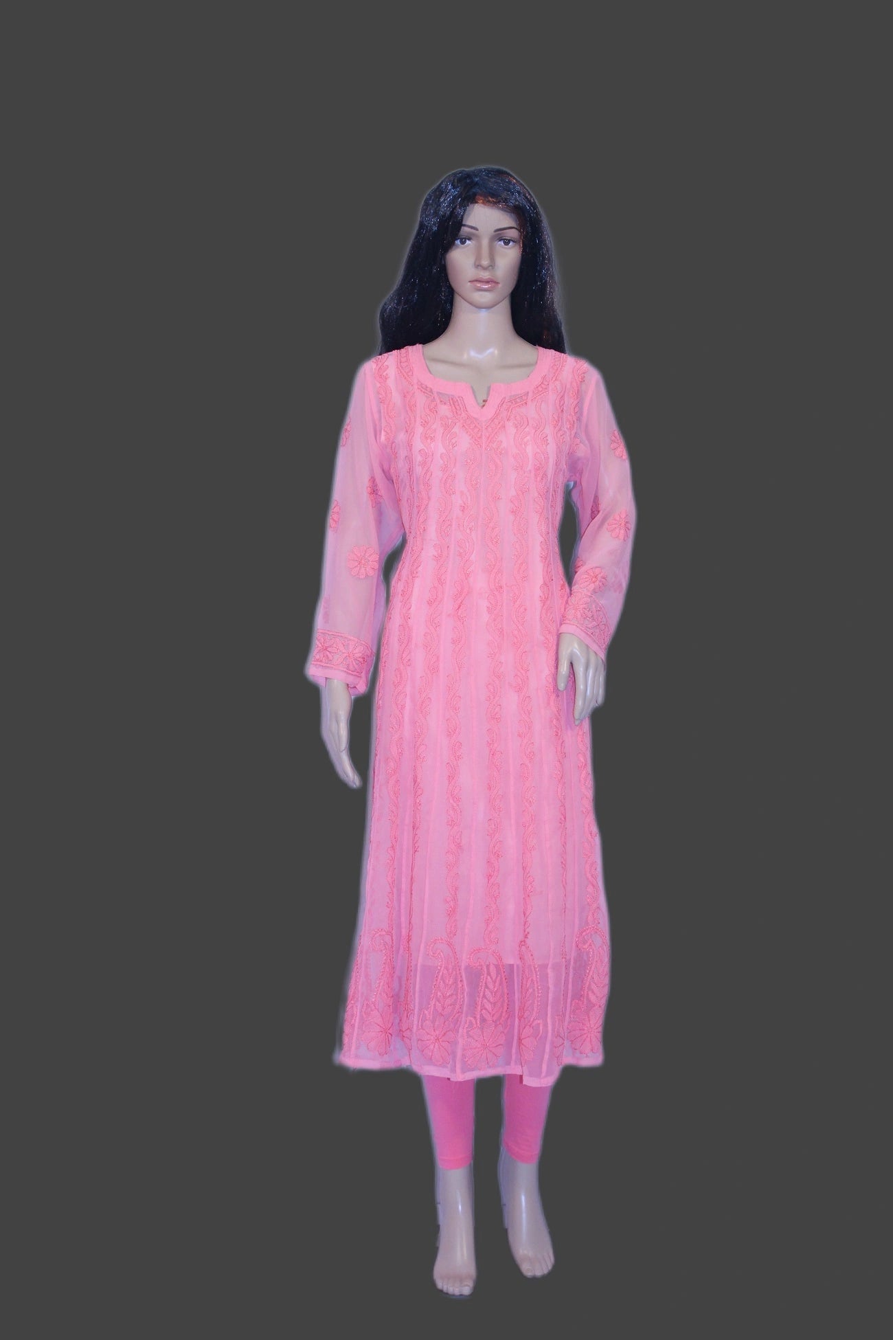 Mannequin wearing a pink dress on a gray background