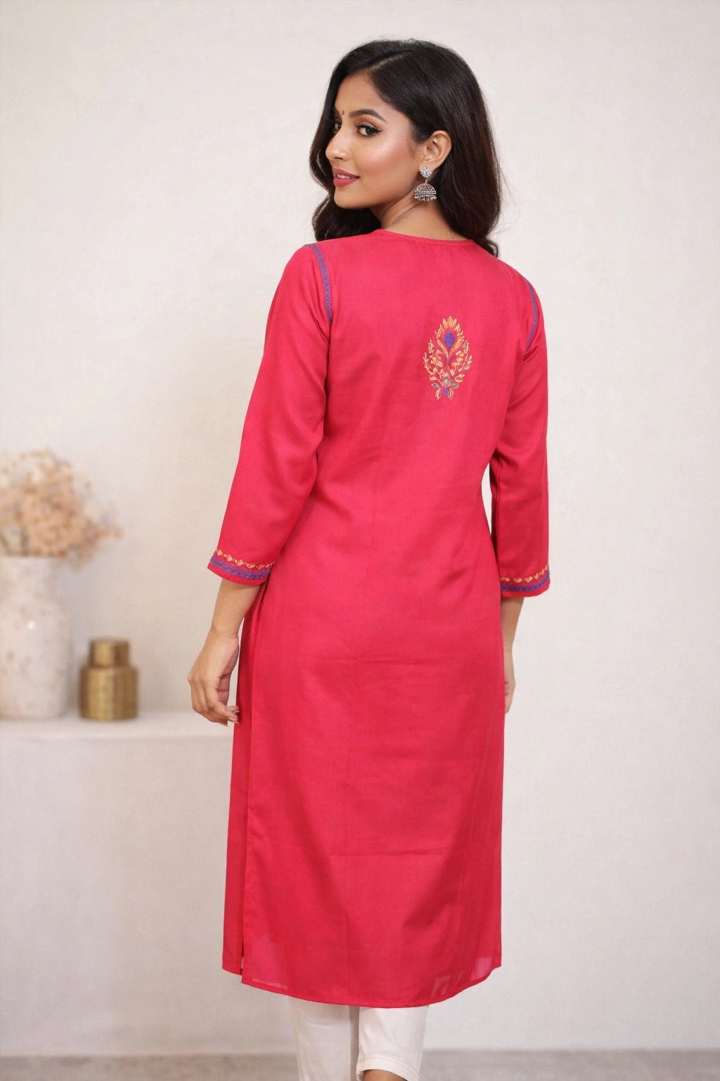 Woman wearing a pink kurta with white background