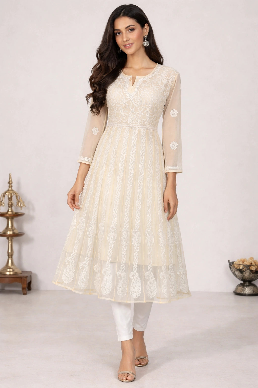 Woman wearing a chikan embroidery light gray dress with a white background