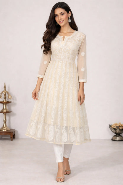 Woman wearing a chikan embroidery light gray dress with a white background